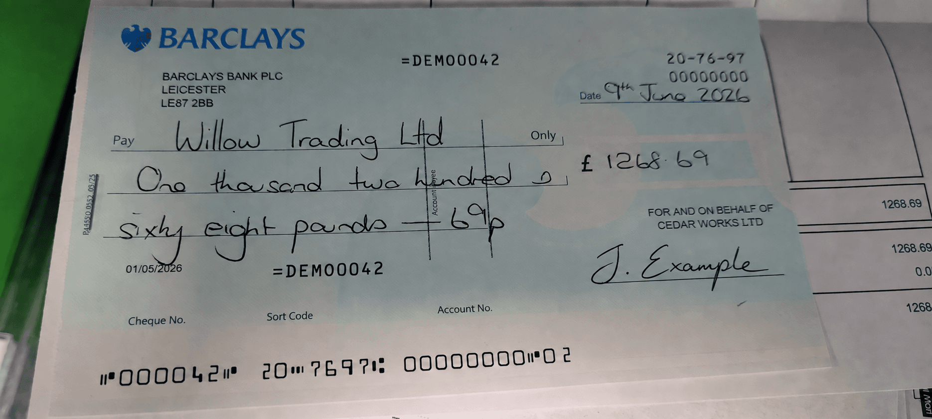 Barclays cheque showing handwritten amounts, payee, date and a MICR line.